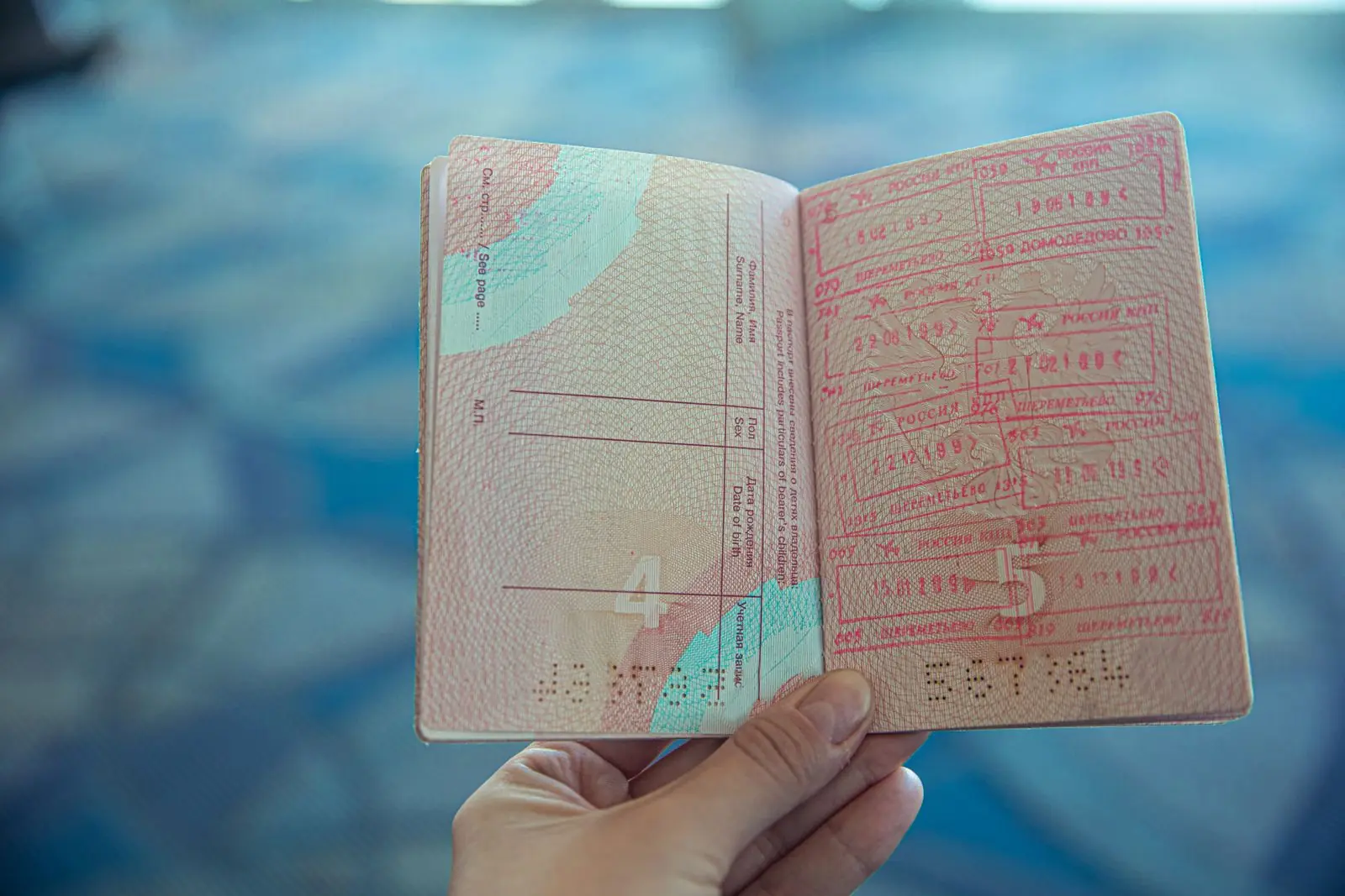 An open passport with visa stamps